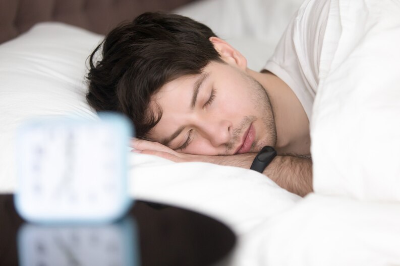 20230803181006 fpdl.in young man sleeping alarm clock wearing smart wristband 1163 5254 medium